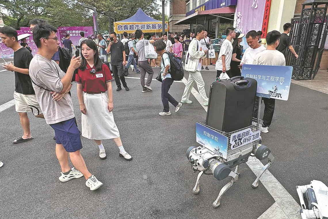 A robotic dog developed by DEEP Robotics helps carry luggage for students at Zhejiang University in Hangzhou, Zhejiang province, on Aug 22, 2025.