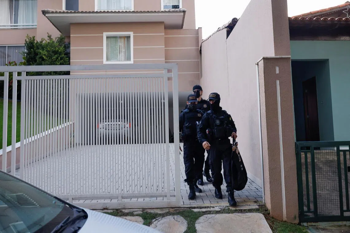Police officers walk outside former Justice Minister Anderson Torres' house after the Brazil's Supreme Court orders his arrest following anti-democratic riots, in Brasilia, Brazil.