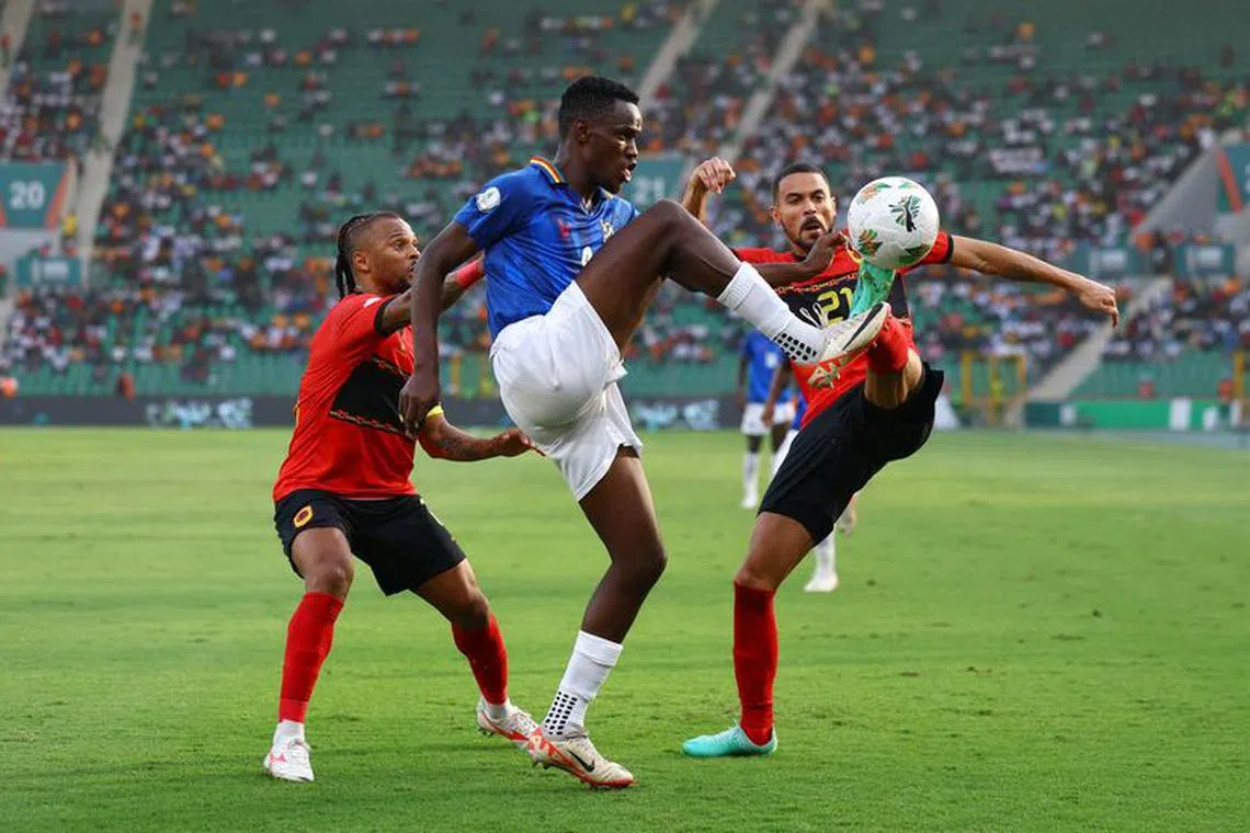Soccer Football - Africa Cup of Nations - Round of 16 - Angola v Namibia - Stade de la Paix, Bouake, Ivory Coast - January 27, 2024 Namibia's Bethuel Muzeu in action with Angola's Eddie Afonso REUTERS/Siphiwe Sibeko