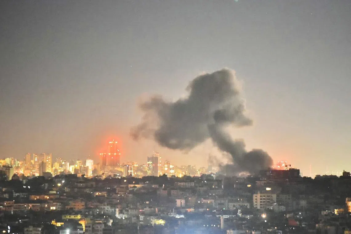 Smoke rises from areas targeted by an Israeli airstrike in Beiruts southern suburbs late on Oct 21.
