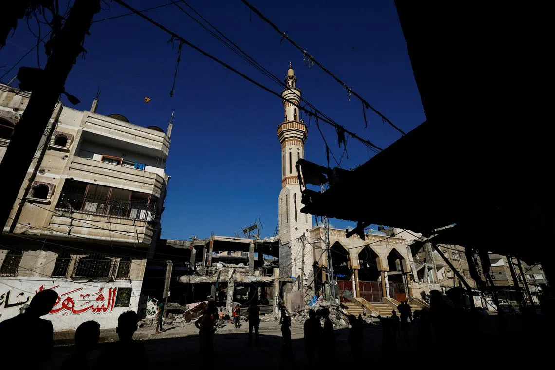 Palestinians stand near the site of an Israeli strike on a house, amid the ongoing conflict between Israel and the Palestinian Islamist group Hamas, in Rafah, in the southern Gaza Strip, April 17, 2024. REUTERS/Mohammed Salem