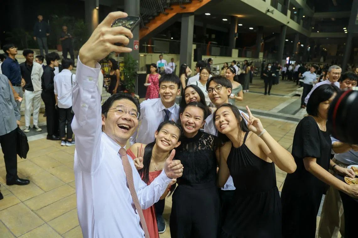 Deputy Prime Minister Lawrence Wong (left) taking a wefie at SSP's 20th anniversary celebration on its Woodlands campus, on April 26.