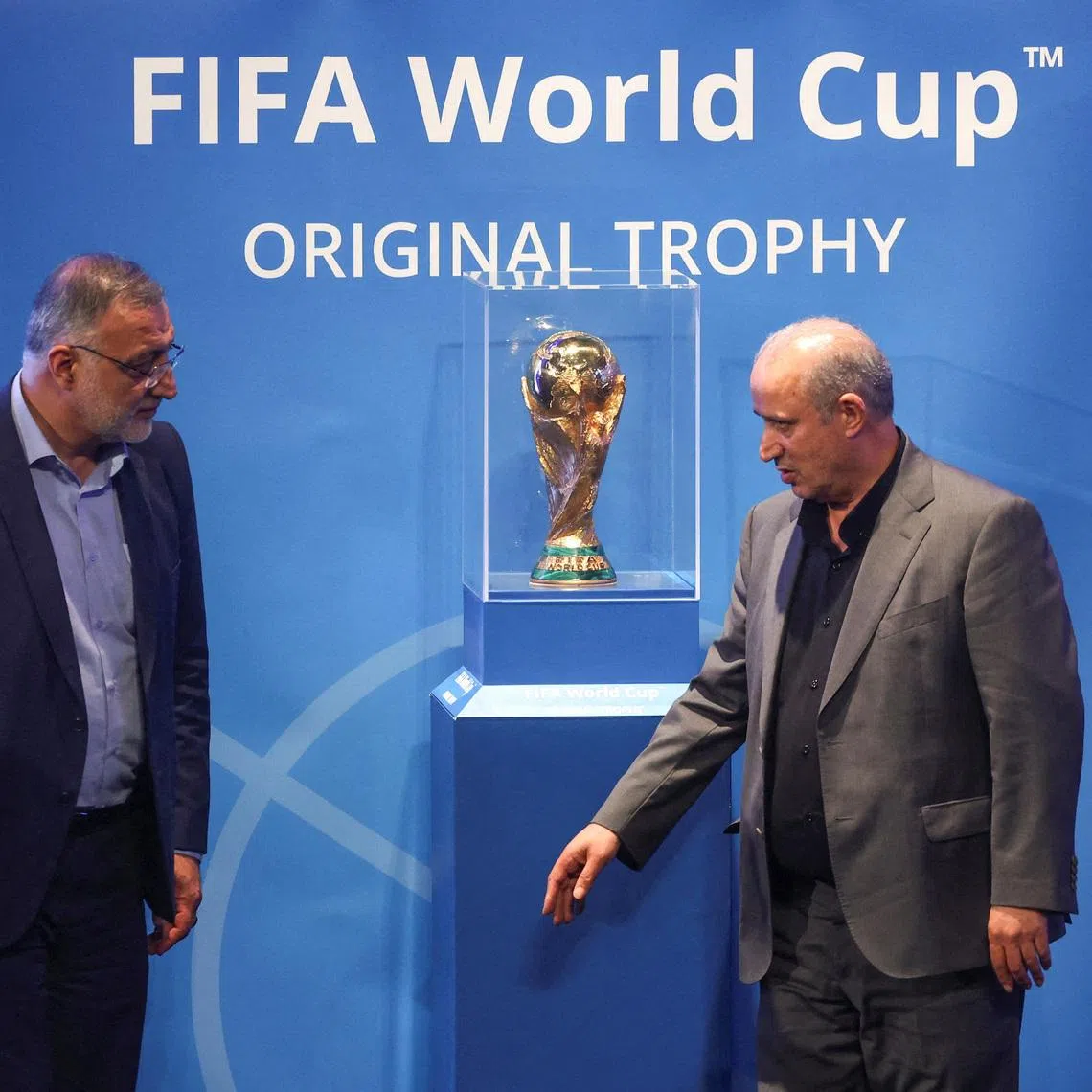 FILE PHOTO: President of Iran Football Federation Mehdi Taj and Mayor of Tehran Alireza Zakani stand next to the FIFA World Cup Trophy during an unveiling ceremony in Tehran, Iran September 1, 2022.  Majid Asgaripour/WANA (West Asia News Agency) via REUTERS /File Photo