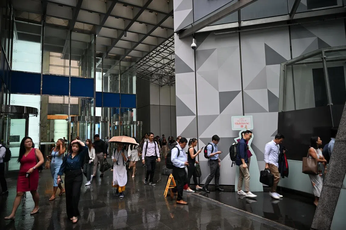 Generic of people at Raffles Place during rush hour on Jan 24, 2024.

Can be used for stories about office workers, Raffles Place, crowd and workers.
