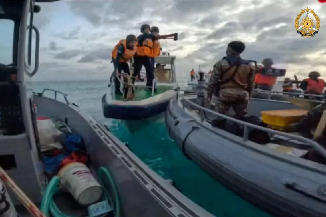 This frame grab from handout video taken on June 17, 2024 and released by the Armed Forces of the Philippines Public Affairs Office on June 19 shows China coast guard personnel (C) appearing to wield bladed weapons during an incident off Second Thomas Shoal in the South China Sea. The Philippine military said on June 19 the Chinese coast guard rammed and boarded Filipino navy boats in a violent confrontation in the South China Sea this week in which a Filipino sailor lost a thumb. China defended its actions, with its foreign ministry saying on Wednesday that "no direct measures" were taken against Filipino personnel. (Photo by Handout / ARMED FORCES OF THE PHILIPPINES-PUBLIC AFFAIRS OFFICE / AFP) / -----EDITORS NOTE --- RESTRICTED TO EDITORIAL USE - MANDATORY CREDIT "AFP PHOTO / ARMED FORCES OF THE PHILIPPINES - PUBLIC AFFAIRS OFFICE" - NO MARKETING - NO ADVERTISING CAMPAIGNS - DISTRIBUTED AS A SERVICE TO CLIENTS