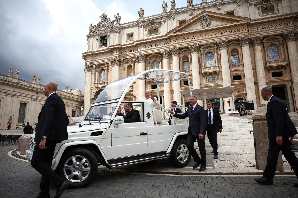 FILE PHOTO: Pope Francis gestures from the Pope mobile, as he attends the weekly general audience, in St. Peter's Square at the Vatican, April 24, 2024. REUTERS/Guglielmo Mangiapane/File Photo