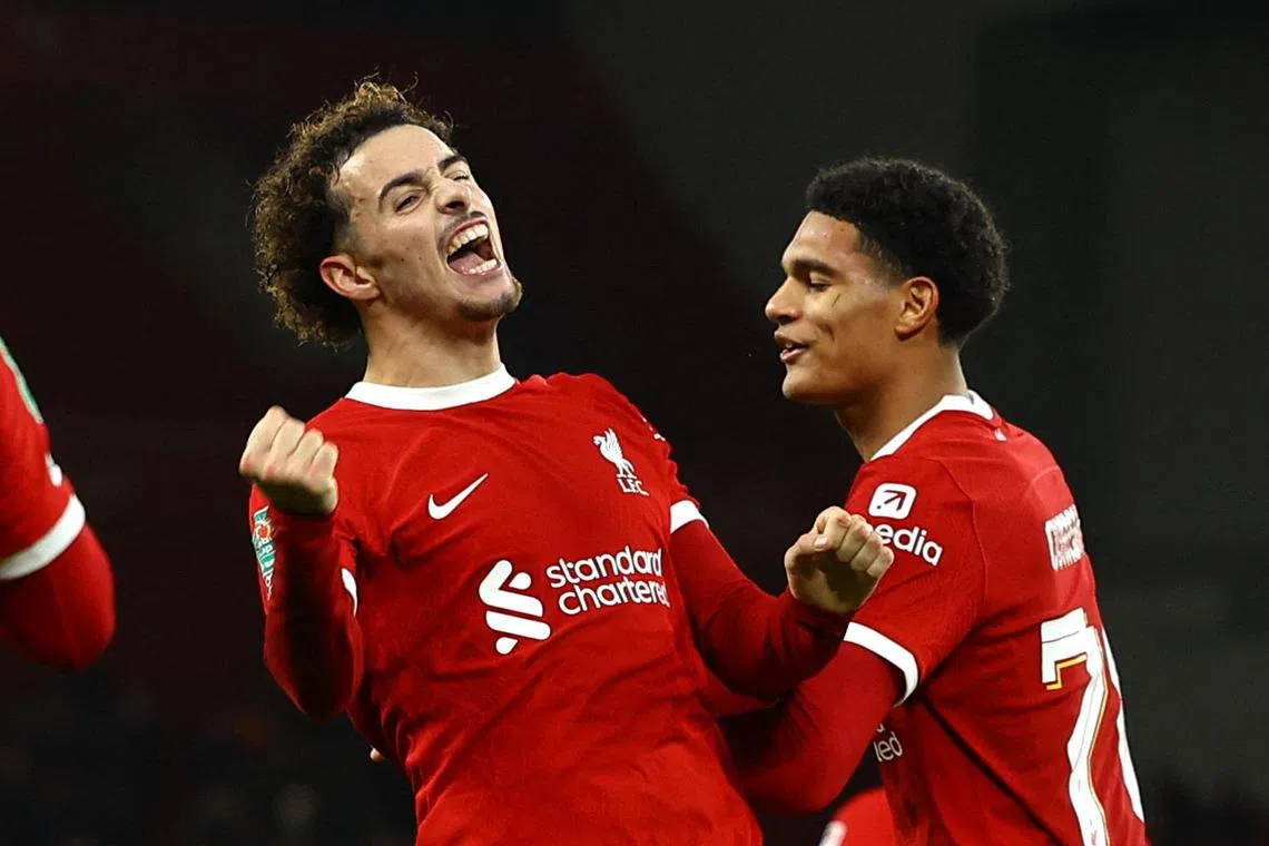Liverpool's Curtis Jones celebrates scoring their fifth goal with teammate Jarell Quansah.