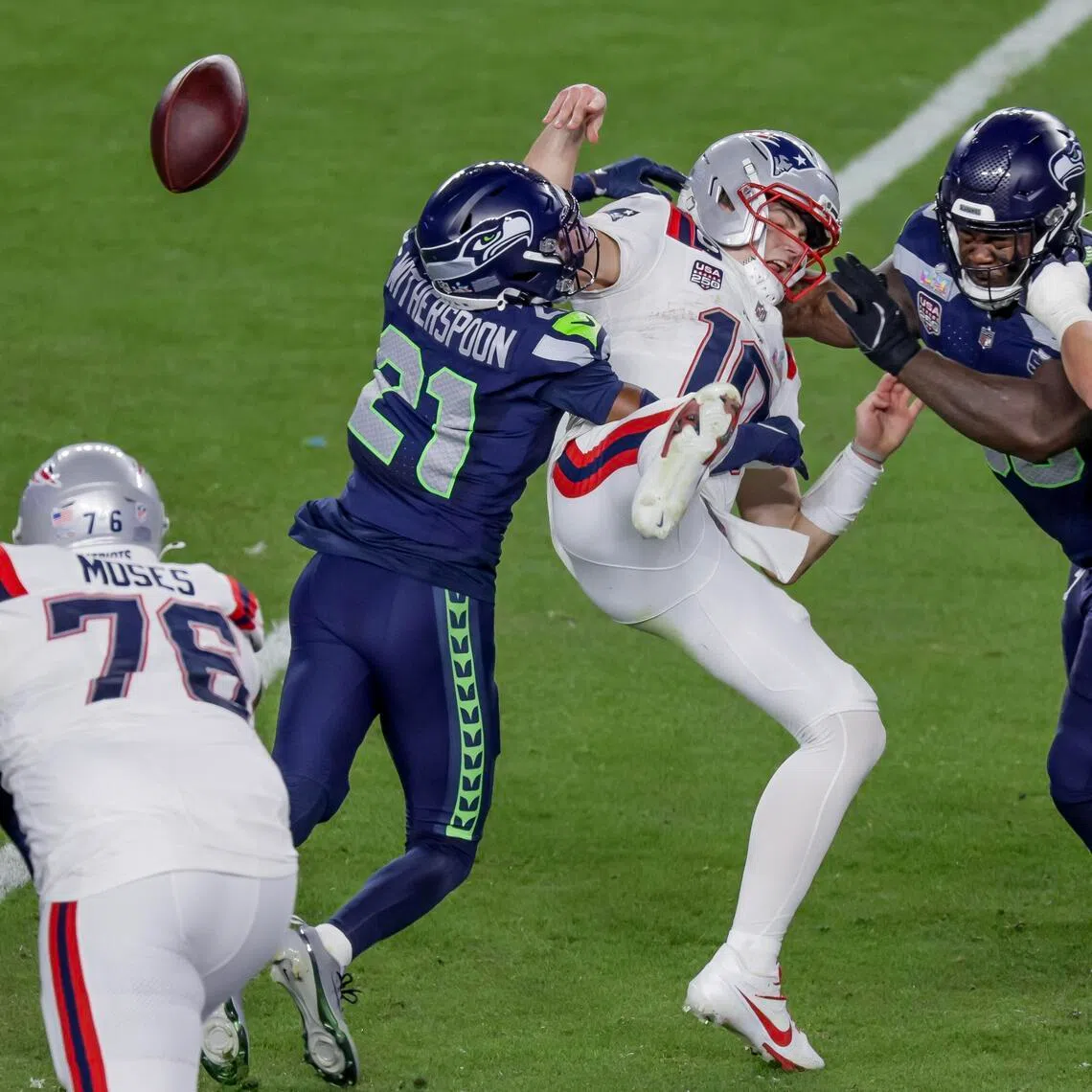 New England Patriots quarterback Drake Maye fumbling the ball under pressure from Seattle Seahawks cornerback Devon Witherspoon (centre) and defensive tackle Jarran Reed during the second half of Super Bowl LX. Seattle won the game 29-13 at the Levi's Stadium in Santa Clara, California, on Feb 8, 2026.