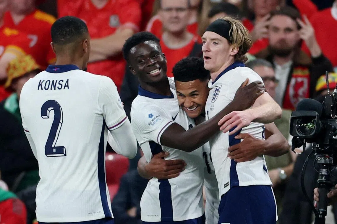 England's Ollie Watkins celebrates scoring their second goal with Bukayo Saka, Anthony Gordon and Ezri Konsa in the 3-0 win over Wales in an international friendly on Oct 9. 