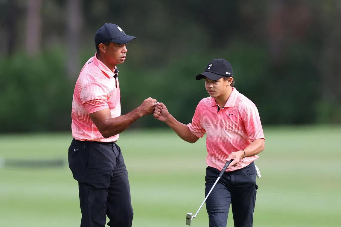 Tiger Woods and his  son Charlie celebrate on the sixth green during the first round of the PNC Championship on Saturday in Orlando, Florida. 