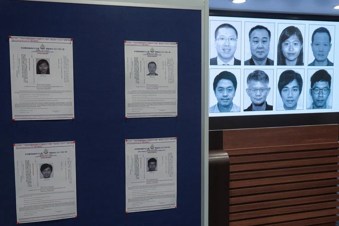 The photos of eight activists who have been issued arrest warrants being displayed during a press conference in Hong Kong on July 3, 2023.