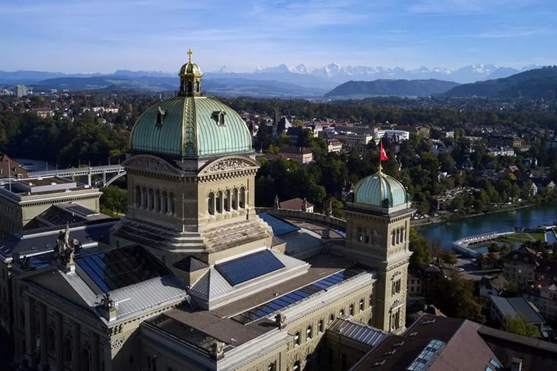 FILE PHOTO: The Swiss Parliament Building (Bundeshaus) is pictured in early autumn light in Bern, Switzerland October 11, 2021. Picture taken with a drone. REUTERS/Denis Balibouse/File Photo