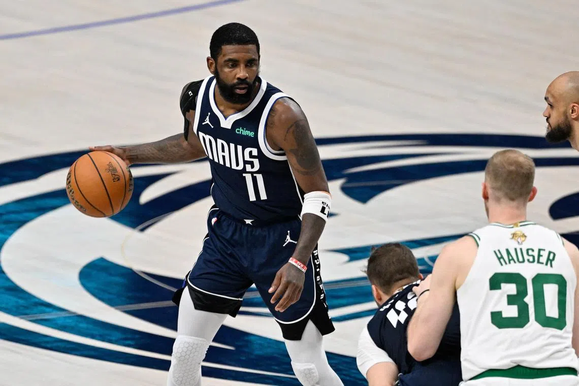 Dallas Mavericks guard Kyrie Irving dribbling at the Boston Celtics during the second half of his team's NBA Finals Game 4 win at American Airlines Centre on June 14.