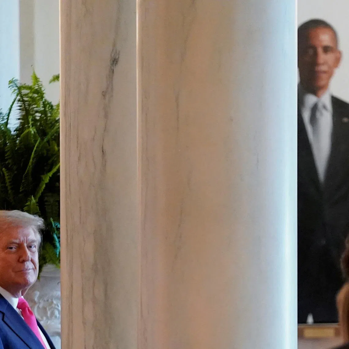 FILE PHOTO: U.S. President Donald Trump looks on as the portrait of former U.S. President Barack Obama can be seen in the background at the White House in Washington, DC., U.S., June 26, 2025. REUTERS/Nathan Howard/ File Photo