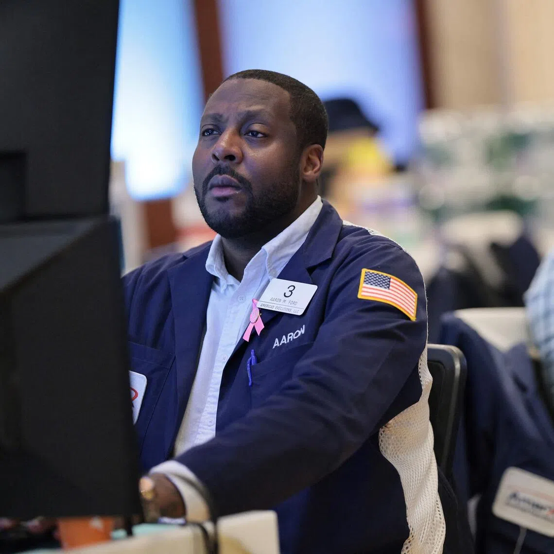 Traders working on the floor of the New York Stock Exchange during morning trading, on Oct 21, in New York City.