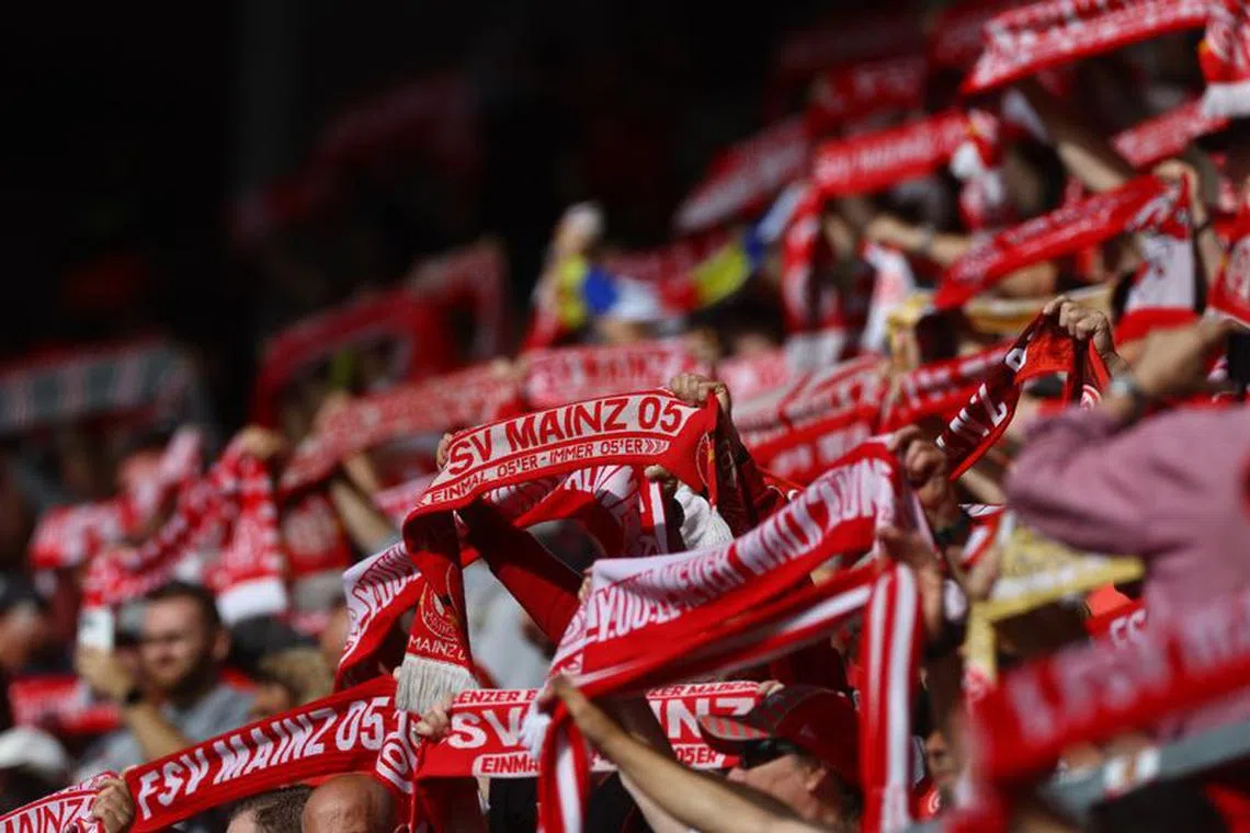 FILE PHOTO: Soccer Football - Bundesliga - 1. FSV Mainz 05 v Bayer Leverkusen - MEWA Arena, Mainz, Germany - September 30, 2023 1. FSV Mainz 05 fans display scarfs inside the stadium before the match REUTERS/Kai Pfaffenbach/File Photo