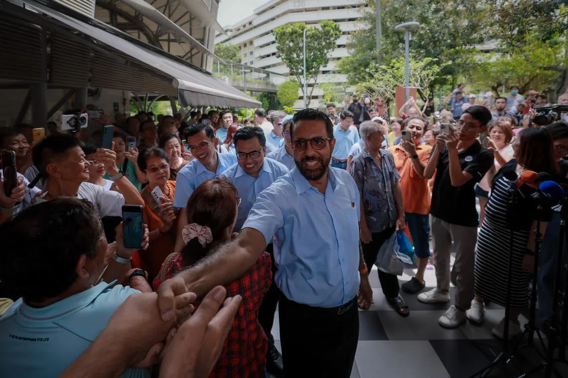 WP chief Pritam Singh and his Aljunied GRC teammates greeting supporters at Blk 630 Bedok Reservoir Road market on May 4.