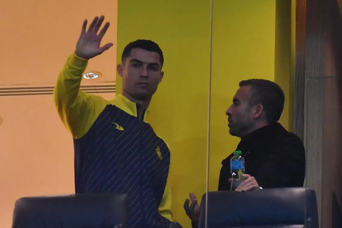 Nassr's Cristiano Ronaldo watches from the VIP area, ahead of a Saudi Pro League match between Al-Nassr and At-Tai.