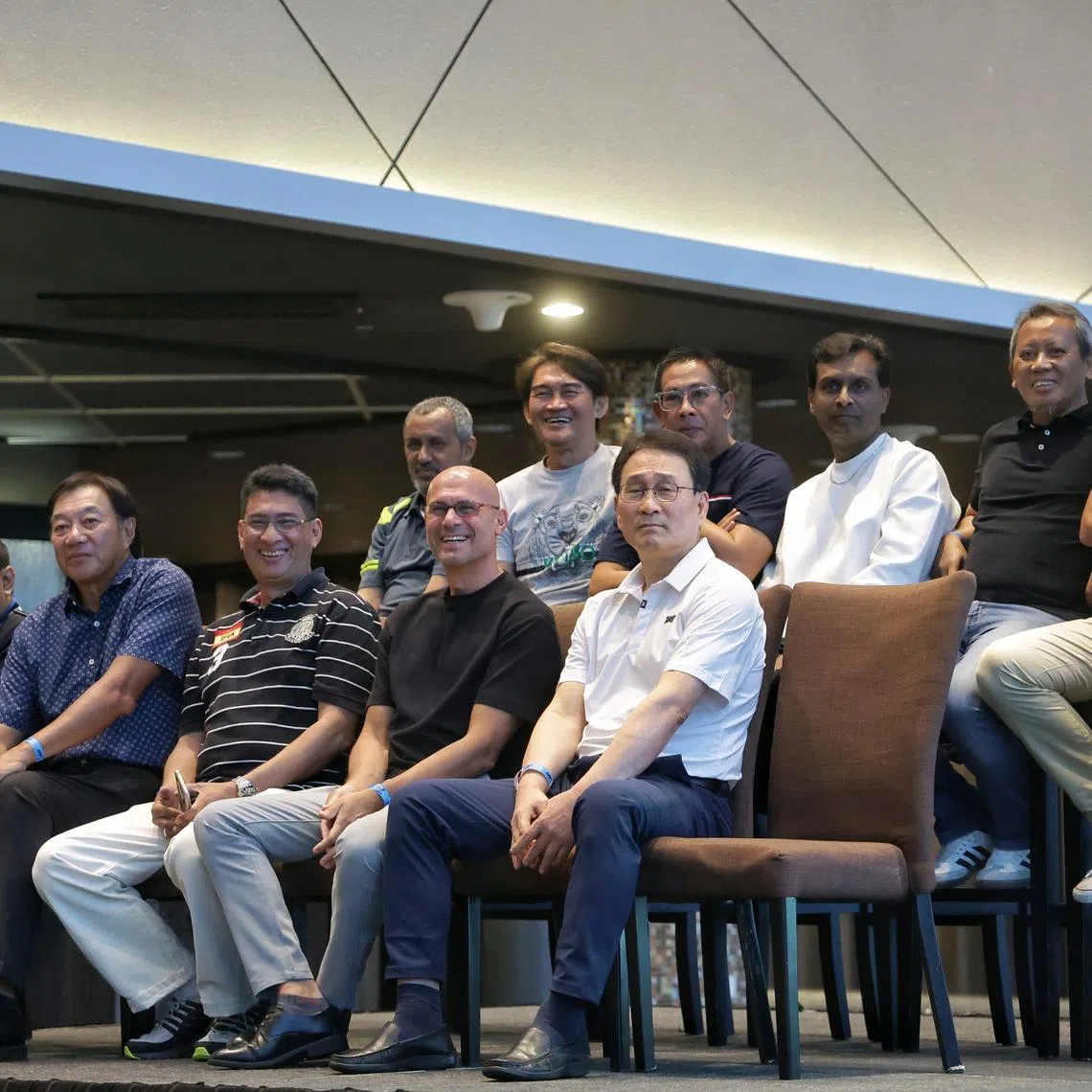 (Front row, from left) 1994 Malaysia league and cup double-winning team's Zakaria Awang, David Lee, Ishamudin Bharoocha, Abbas Saad, Jang Jung, (back row, from left) Malek Awab, Nazri Nasir, Rezal Hassan, T Ramoo, Saswadimata Dasuki, and Rafi Ali watching a video of their winning moments during a celebratory event at Sports Hub's OCBC Lounge on Dec 17, 2024.