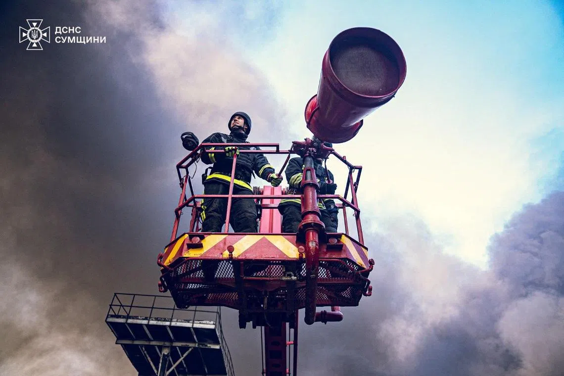 Firefighters work at the site of a Russian missile strike, in Ukraine's Sumy region. 