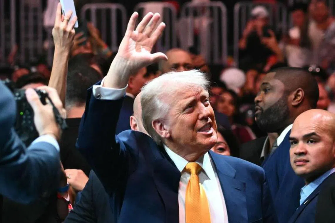(FILES) US President Donald Trump waves to the crowd as he attends UFC 314 at the Kaseya Center in Miami, Florida, on April 12, 2025. Donald Trump is in "excellent health," a White House doctor's assessment said on April 13, 2025, after he underwent his first annual medical checkup since returning to the US presidency. Republican Trump, 78, has repeatedly boasted about his own vigor since starting a second term, while mocking his 82-year-old Democratic predecessor Joe Biden as decrepit and mentally unfit for office. (Photo by Mandel NGAN / AFP)