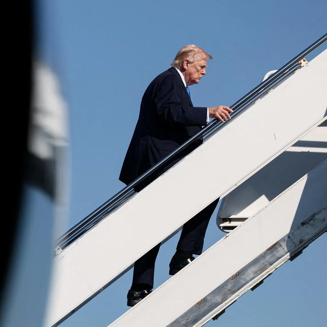 U.S. President Donald Trump boards Air Force One as he departs West Palm Beach, Florida, U.S., March 23, 2026. REUTERS/Kevin Lamarque