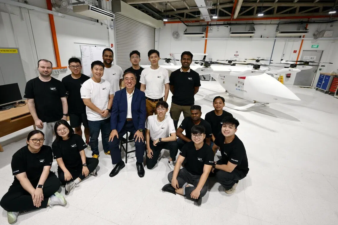 Professor James Wang and his team with a prototype of the 8m eVOTL aircraft.