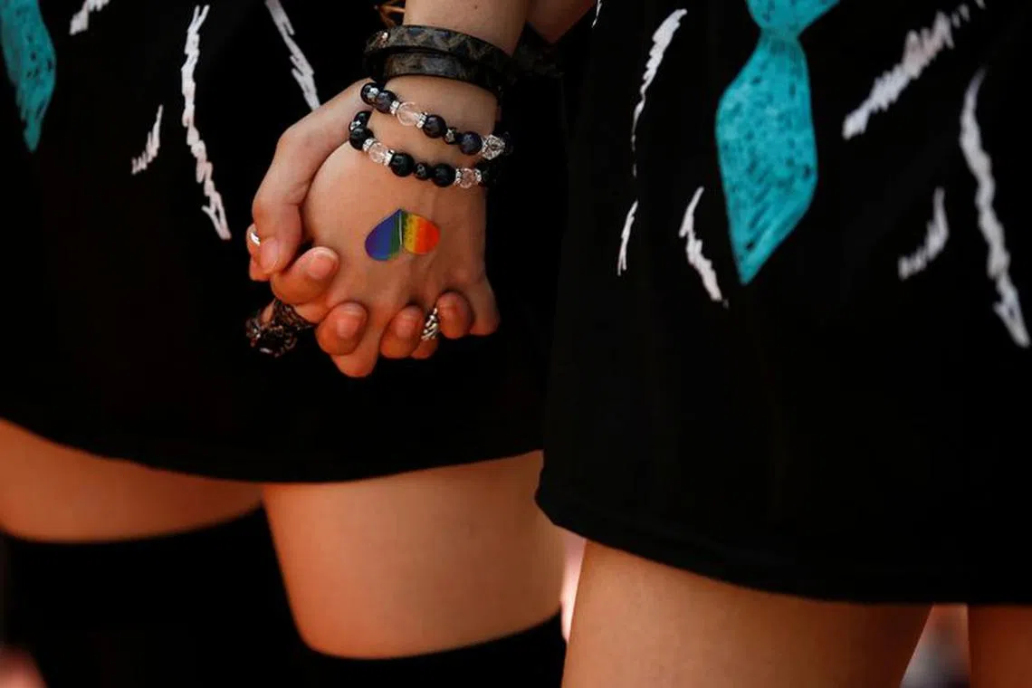 FILE PHOTO: Women hold hands during the Tokyo Rainbow Pride parade celebrating lesbian, gay, bisexual, and transgender (LGBT) culture in Tokyo, Japan, May 8, 2016. REUTERS/Thomas Peter/File Photo
