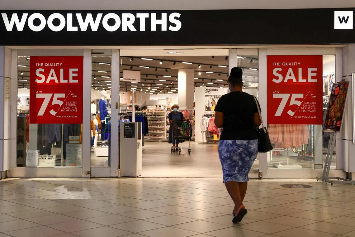 FILE PHOTO: A shopper walks to a Woolworths store in Johannesburg, South Africa, March 2, 2022. REUTERS/Siphiwe Sibeko/File Photo