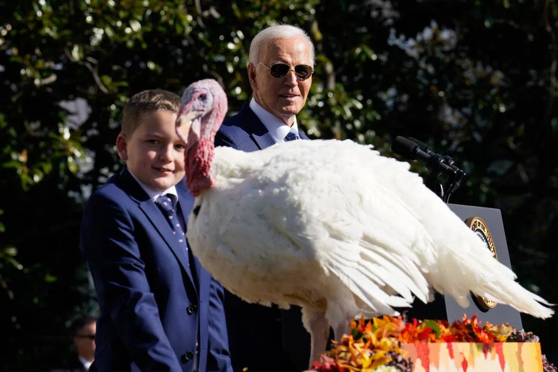 US President Joe Biden (right) pardons one of the National Thanksgiving turkeys, Peach and Blossom from Minnesota, in Washington, DC.