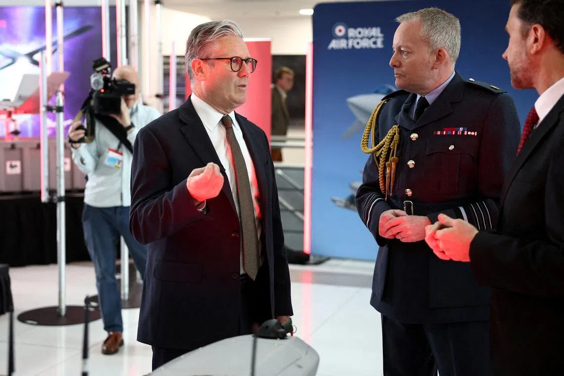 Britain's Prime Minister Keir Starmer speaks with Air Chief Marshal Richard Knighton during a visit to a defence contractor in Bedfordshire, Britain, on May 2.