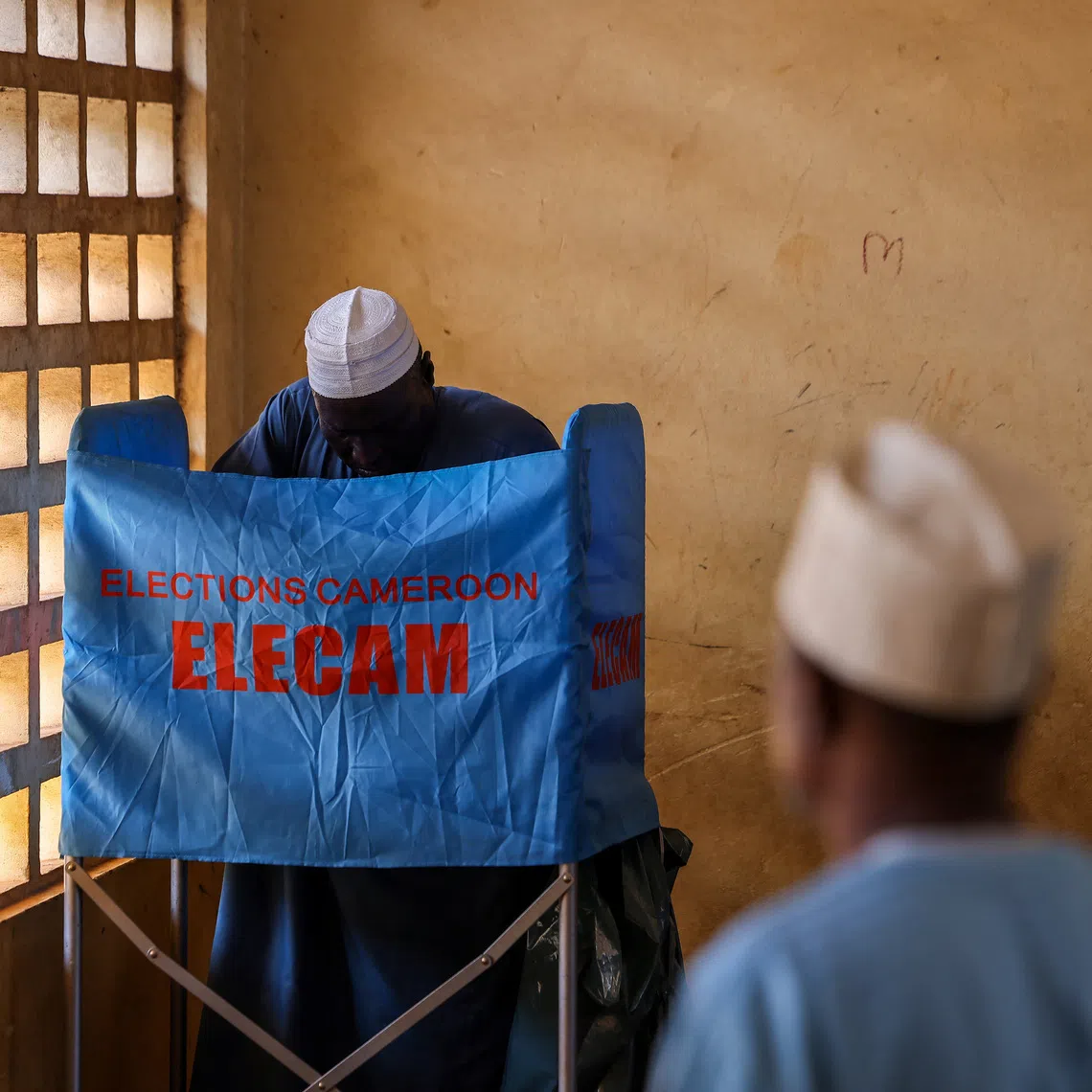 A man votes during the presidential election, in Yaounde, Cameroon October 12, 2025. REUTERS/Zohra Bensemra
