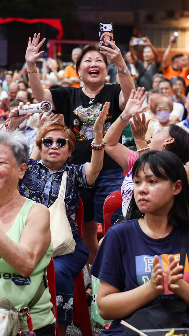 Spectators cheering on Minister for National Development Chee Hong Tat as he sang a Hokkien song at a hungry ghost festival getai show at Toa Payoh Industrial Park on Aug 20, 2026. ST PHOTO: BRIAN TEO.