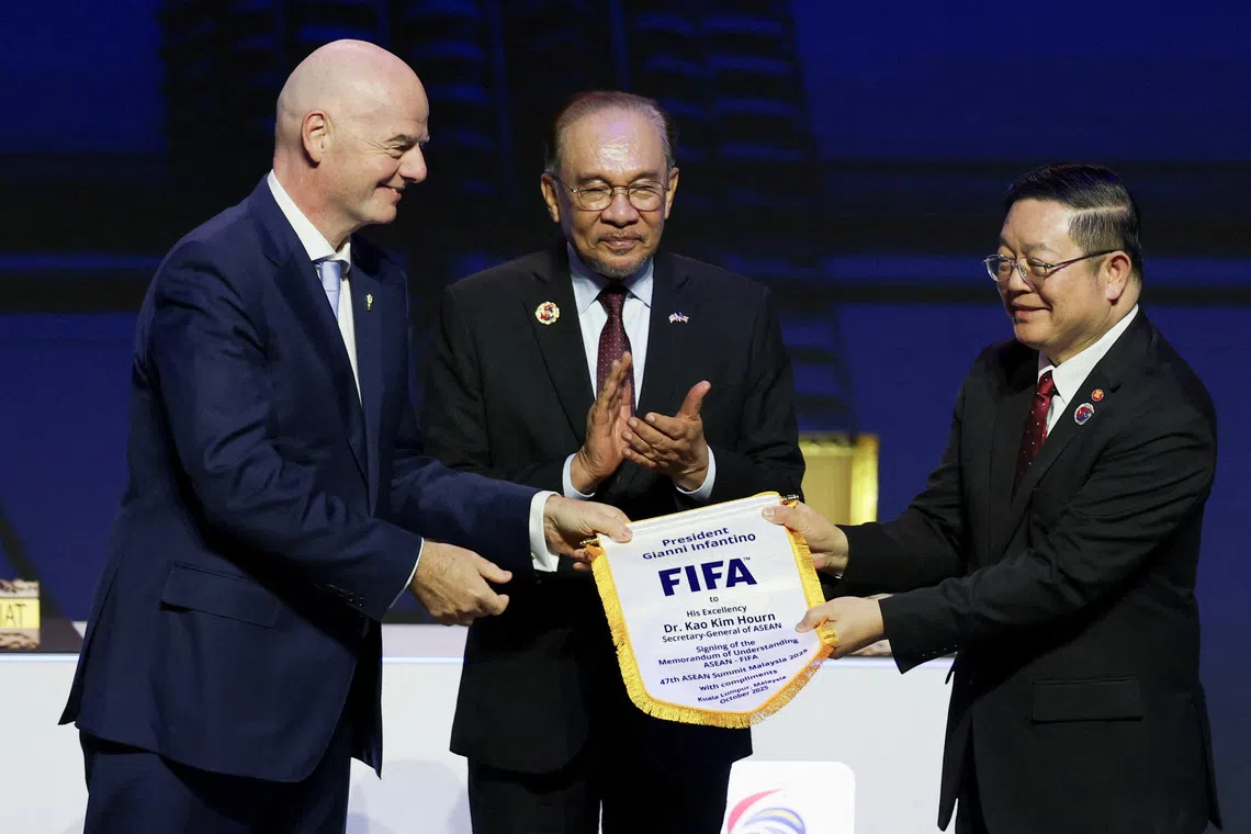 ASEAN Secretary-General Kao Kim Hourn, Malaysian Prime Minister Anwar Ibrahim and FIFA Chief Gianni Infantino attend a signing ceremony for the ASEAN-FIFA memorandum of understanding in football development on the sidelines of the 47th ASEAN Summit in Kuala Lumpur, Malaysia October 26, 2025. REUTERS/Edgar Su