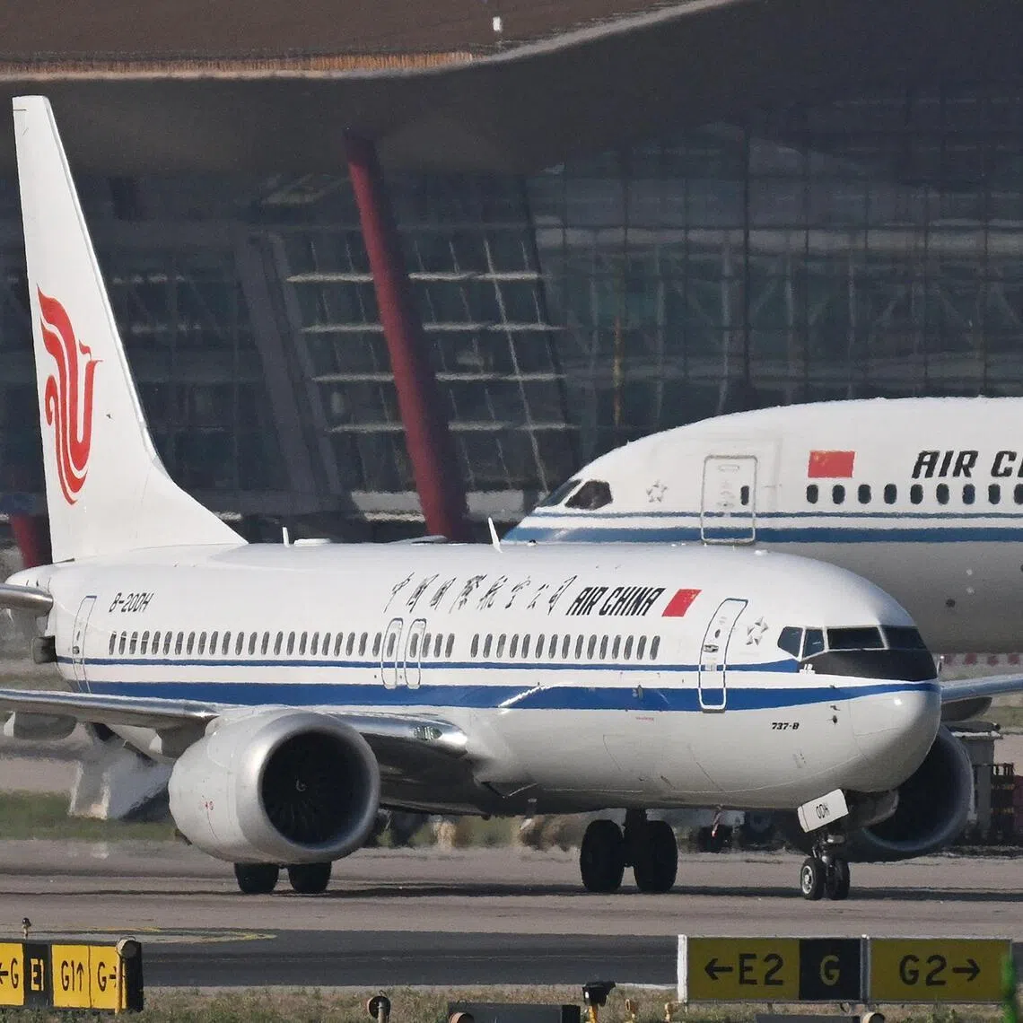 An Air China Boeing 737 MAX 8 taxis in front of an Air China Boeing 787-9 Dreamliner at Beijing Capital Airport in Beijing on May 8.