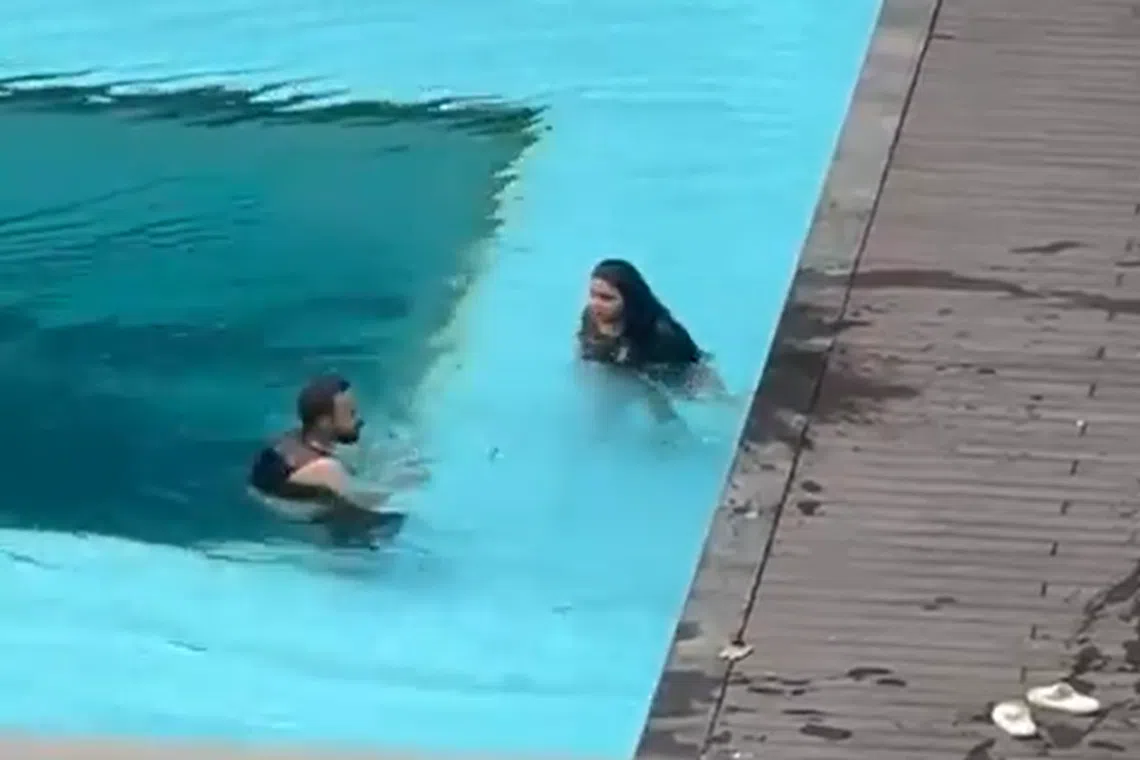The couple in the condominium pool during their altercation, which lasted more than 20 minutes.