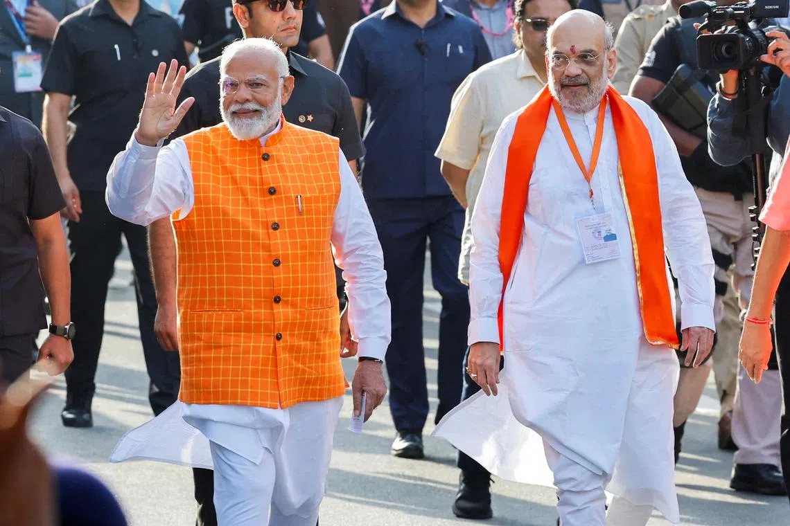 FILE PHOTO: India's Prime Minister Narendra Modi (L) walks alongside Amit Shah, Indian Home Minister and leader of India's ruling Bharatiya Janata Party (BJP) on the day he casts his vote, outside a polling station during the third phase of the general election, in Ahmedabad, India, May 7, 2024. REUTERS/Adnan Abidi/File Photo