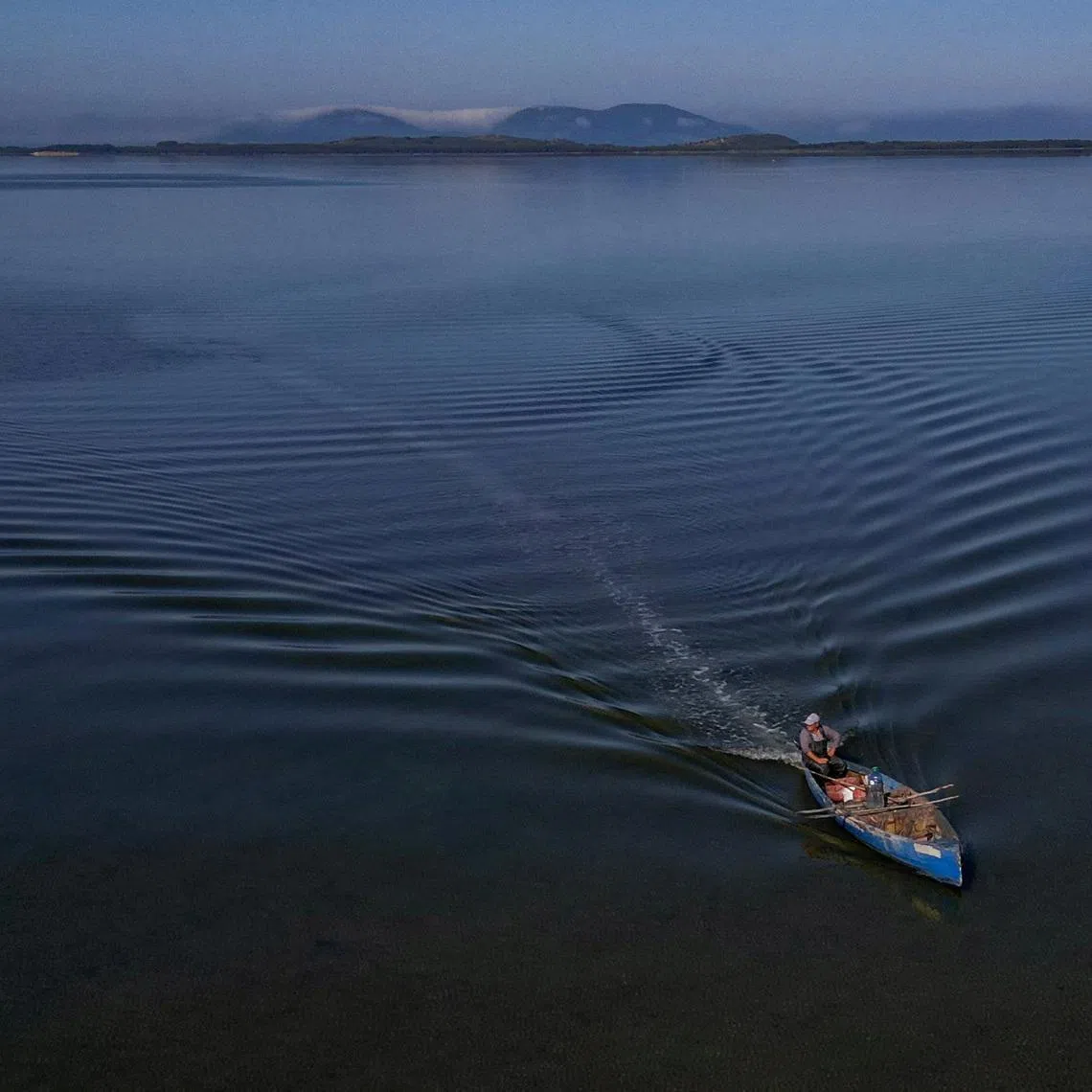 A drone view shows a fisherman sailing his boat near the Vjosa-Narta Protected Area, where a luxury resort is planned by a company linked to Donald Trump's son-in-law, Jared Kushner, in Zvernec near Vlora, Albania, June 10, 2026. REUTERS/Florion Goga