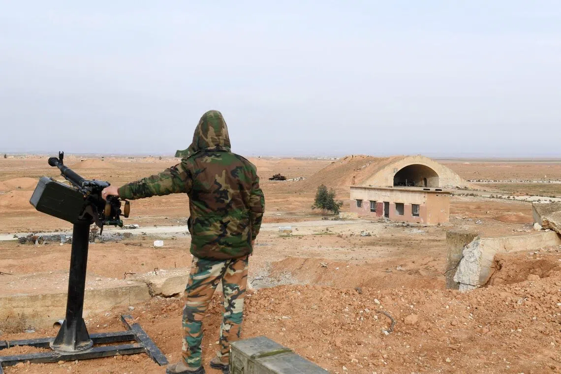 (FILES) A member of Syrian government forces, stands guard the Abu Duhur military air base area in Idlib province, on January 21, 2018. Syria's foreign ministry condemned what it said was an unjustified Israeli attack on an air base in the country's northwest on August 18, 2026, while Israel has not commented on the incident. (Photo by George OURFALIAN / AFP)