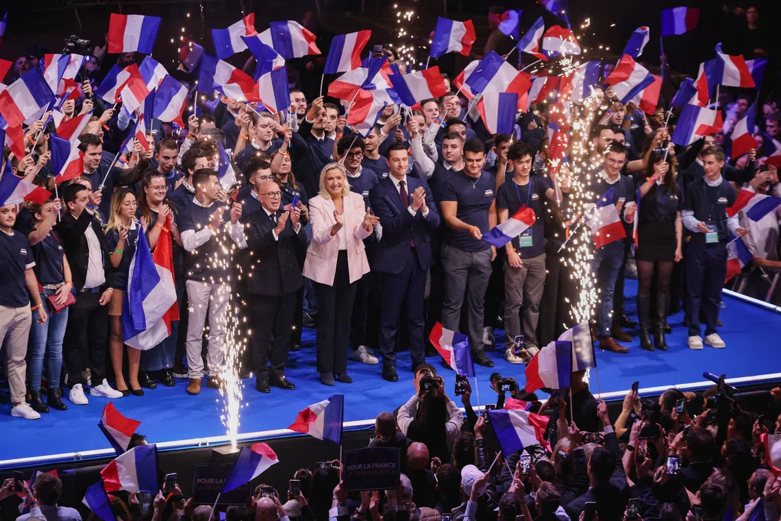 Marine Le Pen (centre), an MP from France’s far-right National Rally party, reacts on stage alongside party president Jordan Bardella and other delegates at the rally.