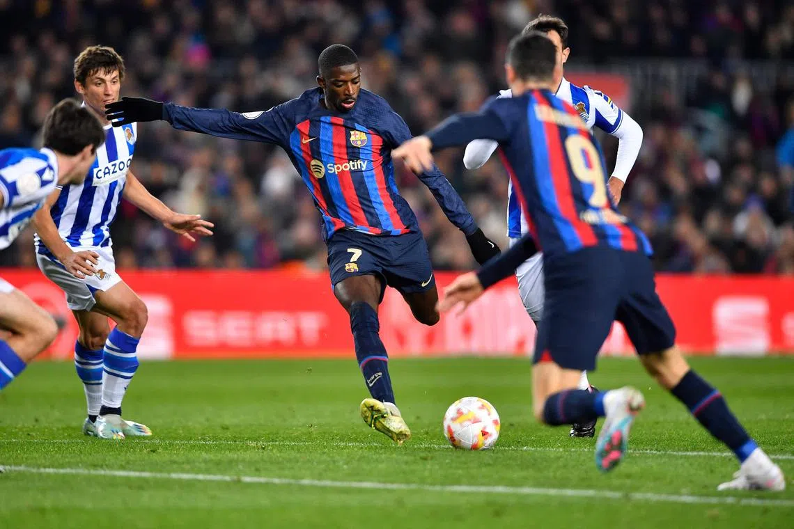 Barcelona's French forward Ousmane Dembele (C) kicks the ball during the Copa del Rey (King's Cup), quarter final football match between FC Barcelona and Real Sociedad, at the Camp Nou stadium in Barcelona on January 25, 2023. (Photo by Pau BARRENA / AFP)