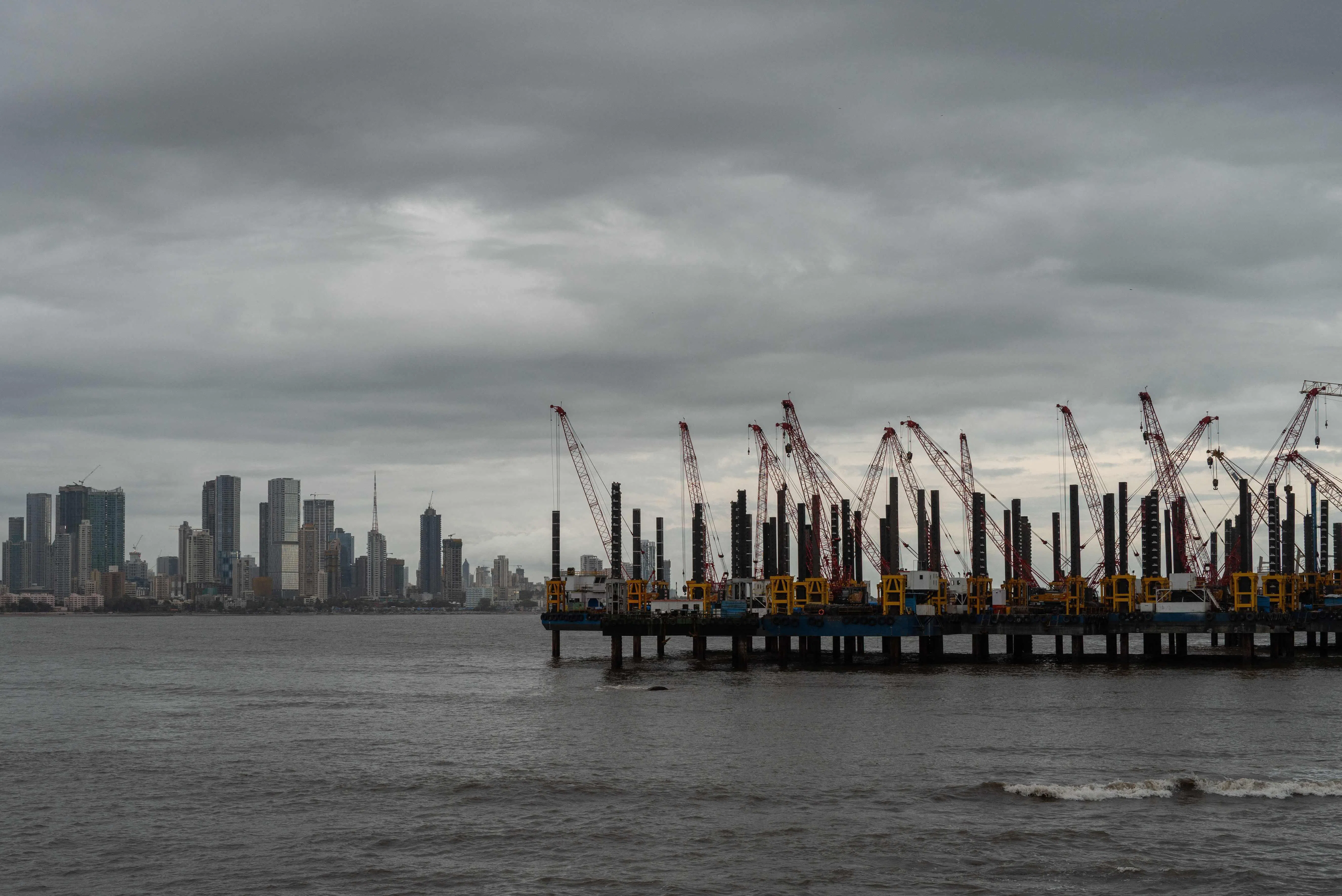 Cranes are seen installed near the Bandra-Worli Sea Link bridge in Mumbai on June 28, 2026. (Photo by Punit PARANJPE / AFP)