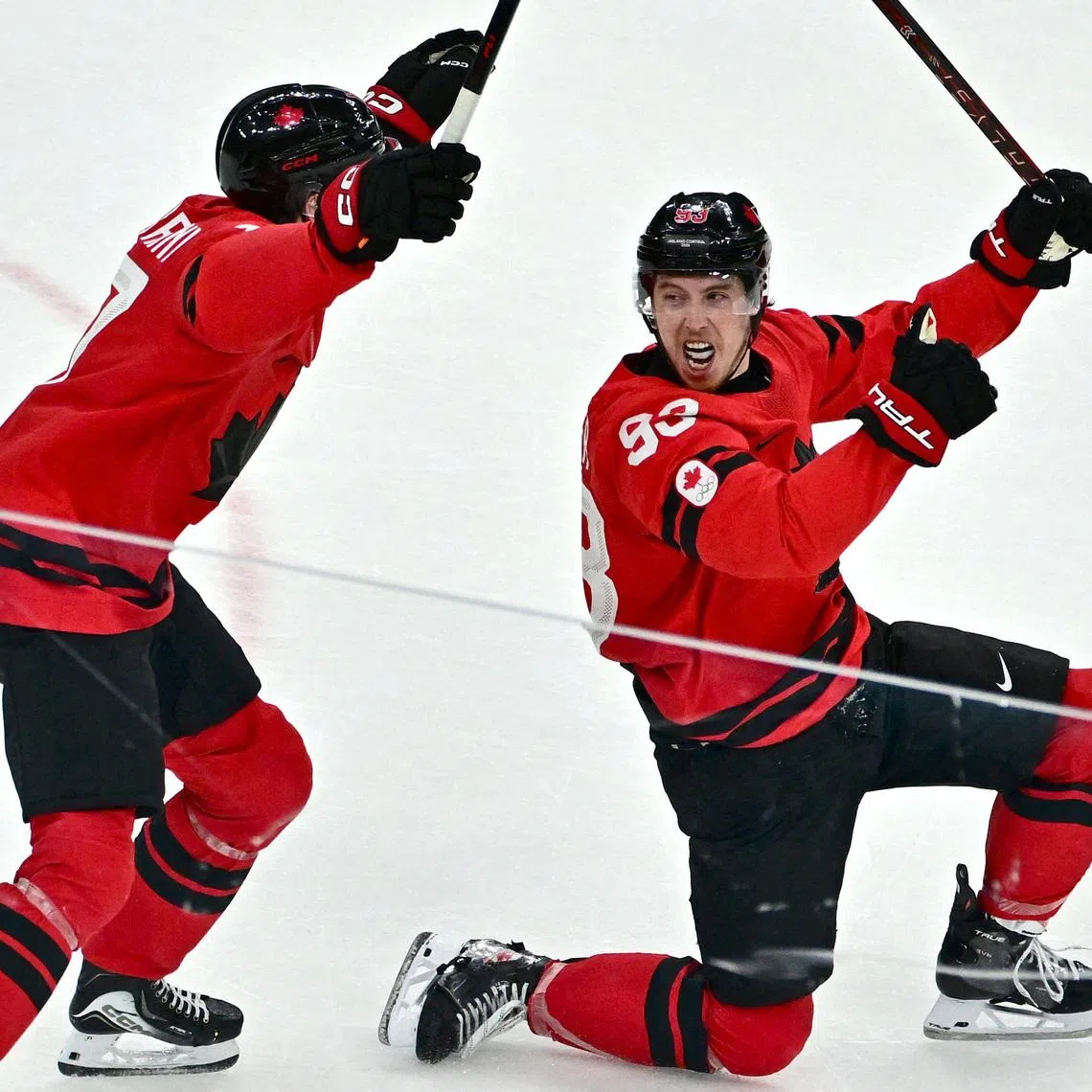 Milano Cortina 2026 Olympics - Ice Hockey - Men's Play-offs Quarterfinals - Canada vs Czech Republic - Milano Santagiulia Ice Hockey Arena, Milan, Italy - February 18, 2026. Mitch Marner of Canada celebrates with Macklin Celebrini after scoring their fourth goal in overtime to win the match REUTERS/Marton Monus
