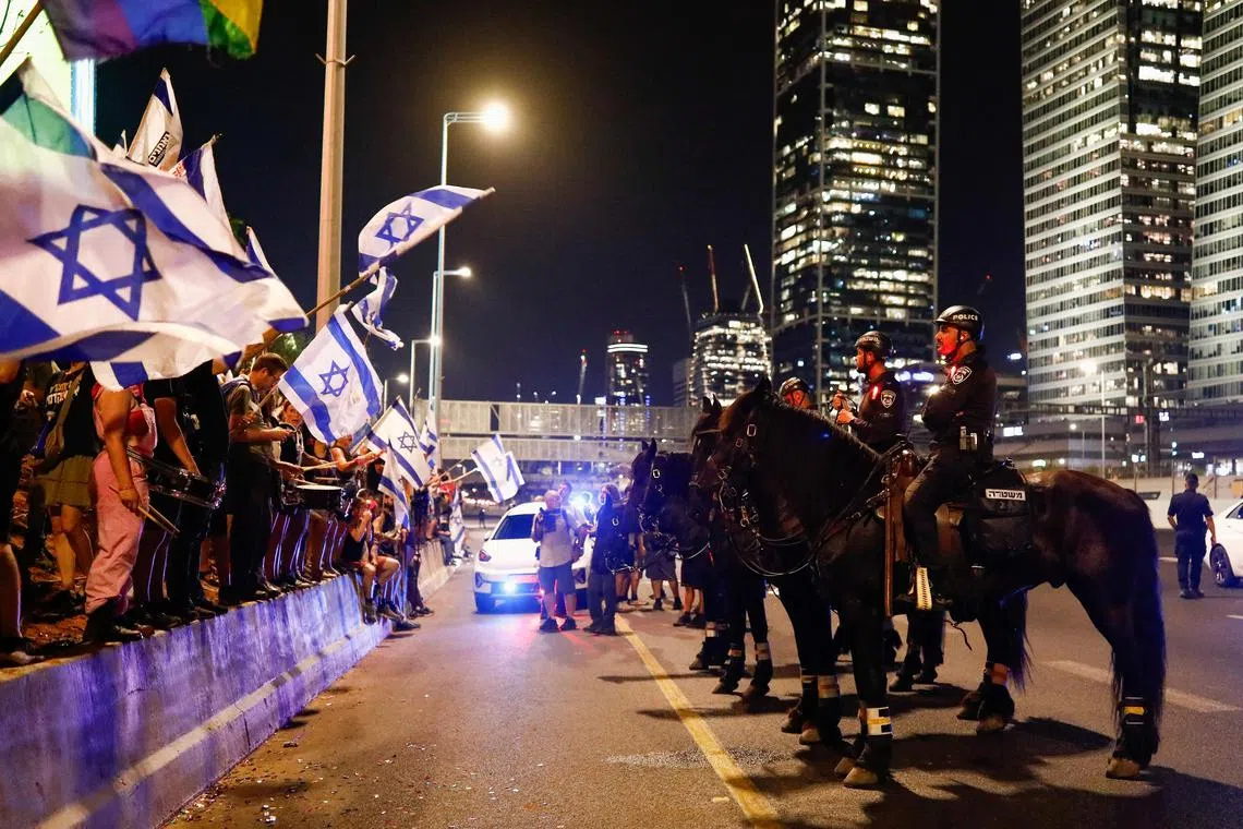 Police officers on guard at a protest in Tel Aviv against the government's judicial overhaul.