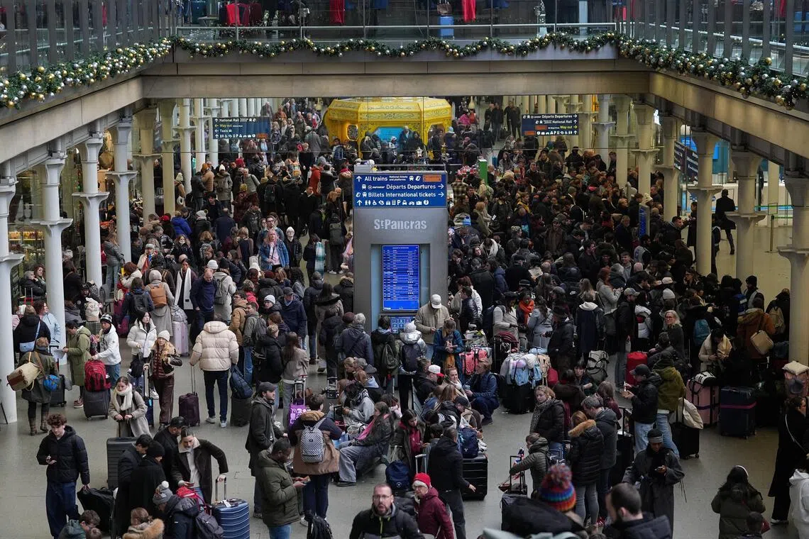 Passengers taking Eurostar trains crowd the St Pancras international station in London.
