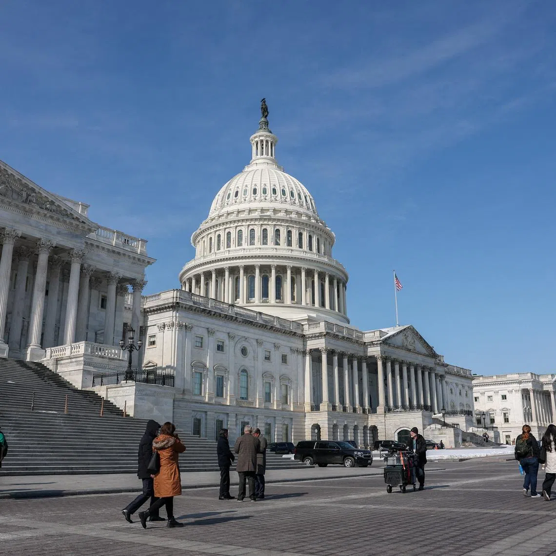 People walk near the U.S. Capitol building in Washington, D.C., U.S., February 4, 2026. REUTERS/Kylie Cooper