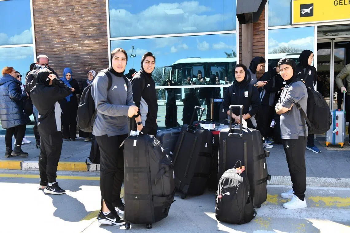 Members of Iran's women's football team stand at Igdir airport, waiting to reach Dogubeyazit, in Igdir on March 18, 2026. 