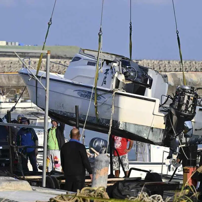 The Fukutsu, one of two boats that capsized in Nago, Okinawa, in March, being brought ashore on March 16. Two people, including a 17-year-old student, died in the incident.