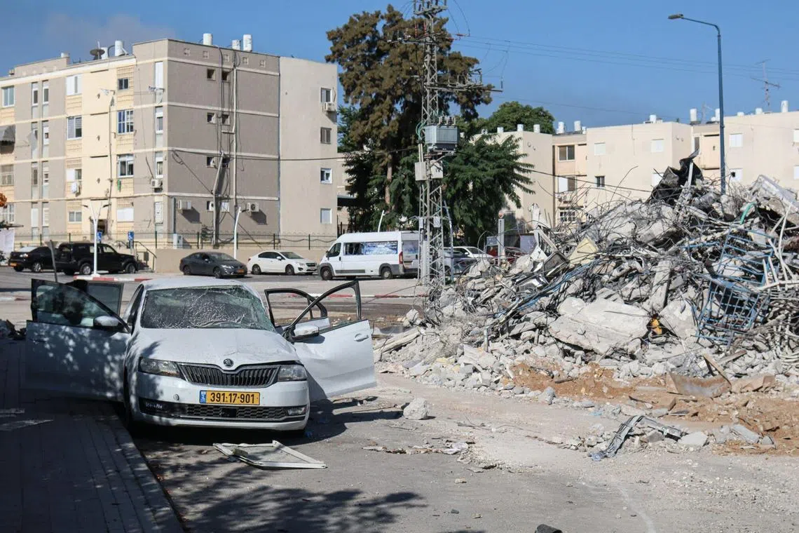 Damage to vehicle and a building following a missile attack by Hamas militants in Sderot, southern Israel.