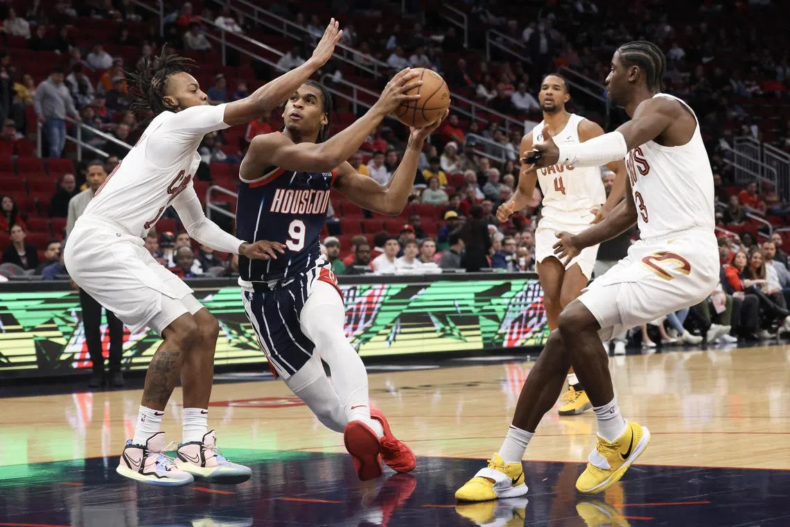 Houston Rockets guard Josh Christopher (9) splits the defense of Cleveland Cavaliers forward Mamadi Diakite (21) and guard Caris LeVert (3) but the Rockets were ultimately soundly beaten.